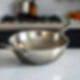 A sleek stainless-steel sauté pan showcasing its polished surface and ergonomic handle.