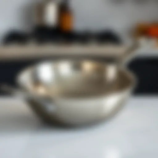 A sleek stainless-steel sauté pan showcasing its polished surface and ergonomic handle.
