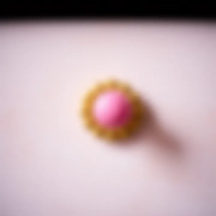 Close-up of a pink and gold drawer knob against a textured background