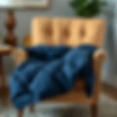 Navy Blue Quilt on Cozy Chair Navy blue quilt folded neatly on a cozy chair
